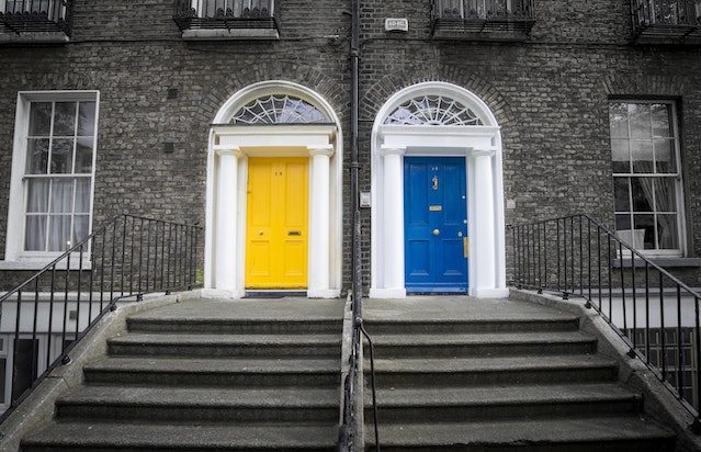 A blue and yellow door of town house neighbours